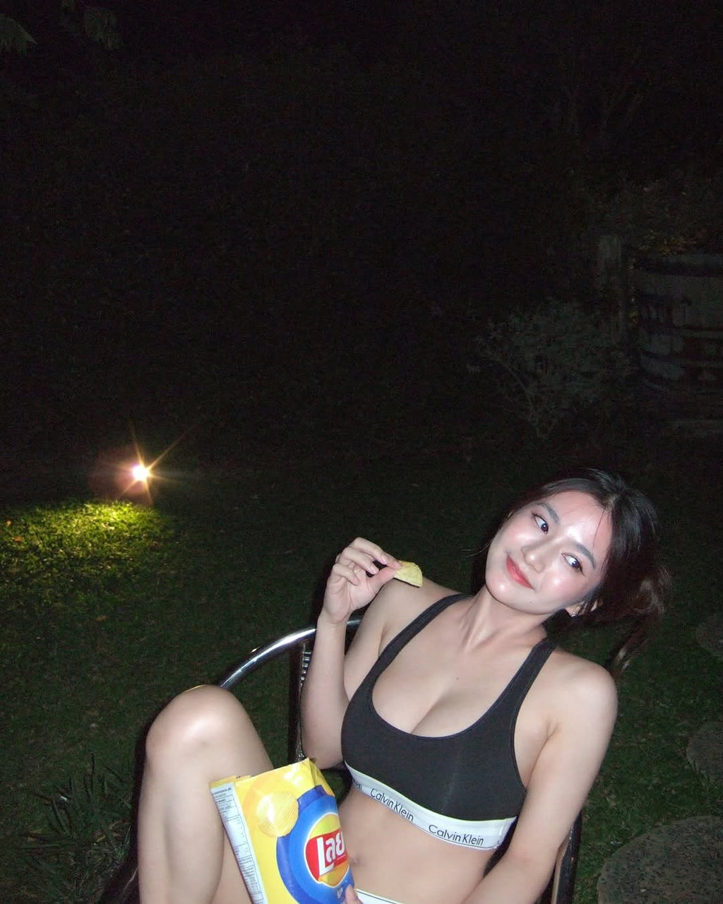 Bikini demo photo in the garden at night.